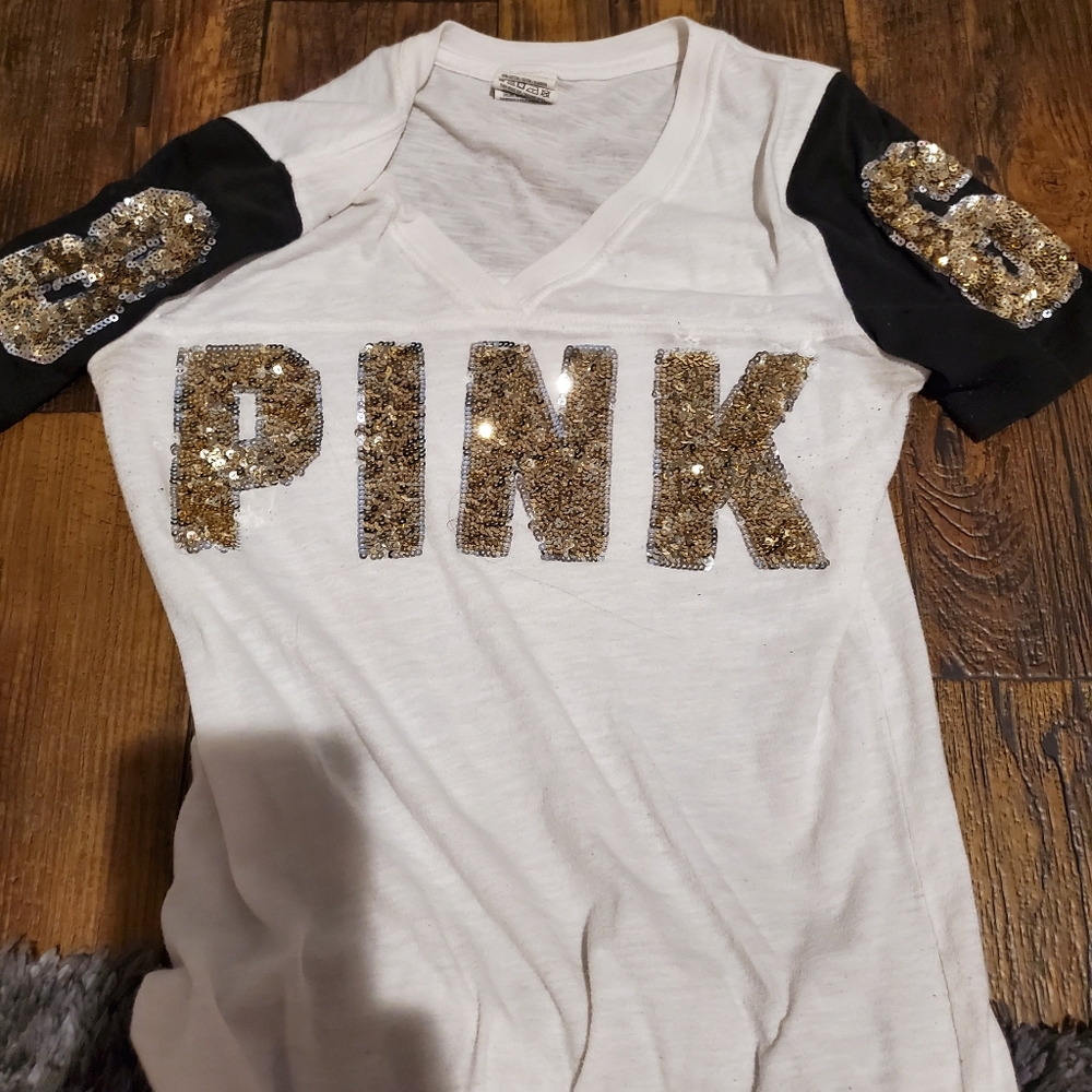 A white shirt with black on the sleeves